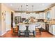 Modern kitchen featuring a large island with seating, stainless steel appliances, and stylish white cabinetry at 12245 Olivetta Ct, Las Vegas, NV 89138