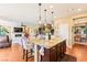 Open-concept kitchen featuring a large island, granite countertops, and seamless flow into the living area at 12245 Olivetta Ct, Las Vegas, NV 89138