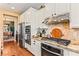 Modern kitchen features stainless steel appliances, white cabinetry, granite countertops, and a stylish backsplash at 12245 Olivetta Ct, Las Vegas, NV 89138