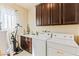 Well-equipped laundry room with cabinets, washer, dryer, and ample counter space at 12245 Olivetta Ct, Las Vegas, NV 89138