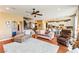 Open-concept living space with hardwood floors seamlessly connecting the living room, dining area, and kitchen at 12245 Olivetta Ct, Las Vegas, NV 89138
