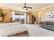 Bright bedroom featuring balcony access, neutral walls, ceiling fan, and ample space at 12245 Olivetta Ct, Las Vegas, NV 89138