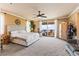 Spacious bedroom featuring a king bed, a ceiling fan, and a private balcony entrance at 12245 Olivetta Ct, Las Vegas, NV 89138