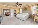 This spacious bedroom features natural light, a ceiling fan, and seamless access to the living room at 12245 Olivetta Ct, Las Vegas, NV 89138
