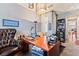 Spacious home office with a large desk, a leather chair, and plenty of natural light at 12245 Olivetta Ct, Las Vegas, NV 89138