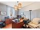 Comfortable home office featuring a large desk, ample lighting, and a relaxed seating area at 12245 Olivetta Ct, Las Vegas, NV 89138