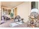 Cozy front patio area with comfortable seating, a cafe sign, and neutral tones at 12245 Olivetta Ct, Las Vegas, NV 89138