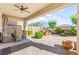Inviting covered patio with stylish seating and a fan, perfect for outdoor living at 12245 Olivetta Ct, Las Vegas, NV 89138