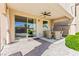 Covered patio features comfortable wicker seating, ideal for enjoying the outdoors at 12245 Olivetta Ct, Las Vegas, NV 89138