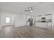 Open-concept living area with light wood floors, stainless steel appliances and white cabinets at 1701 Desert Path Ave, North Las Vegas, NV 89032