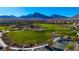 Stunning aerial view of a neighborhood park, playground, and mountain landscape at 193 Elder View Dr, Las Vegas, NV 89138