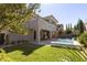 Beautiful backyard featuring a pool, lush lawn, and a covered patio, perfect for outdoor living at 193 Elder View Dr, Las Vegas, NV 89138