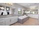 Elegant bathroom with double sinks, soaking tub, and abundant natural light at 193 Elder View Dr, Las Vegas, NV 89138