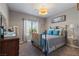 Cozy bedroom with a charming iron bed and a well-lit window at 193 Elder View Dr, Las Vegas, NV 89138