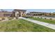 Welcoming community entrance with lush green lawns, stone signage, and beautifully designed archways at 193 Elder View Dr, Las Vegas, NV 89138