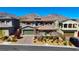 Charming two-story home with a three car garage, landscaped yard, and a desert backdrop at 193 Elder View Dr, Las Vegas, NV 89138