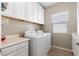 Convenient laundry room with modern washer, dryer, and ample storage space at 193 Elder View Dr, Las Vegas, NV 89138