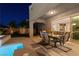 Elegant covered patio with dining area and seamless access to the backyard pool and spa at 193 Elder View Dr, Las Vegas, NV 89138
