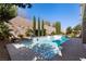 Inviting pool area surrounded by elegant landscaping, mature trees and a brick retaining wall at 193 Elder View Dr, Las Vegas, NV 89138