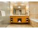 Bathroom featuring double vanity with large mirror, a glass shower, and soaking tub with tile surround at 2000 Fashion Show Dr # 5300, Las Vegas, NV 89109
