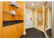 Hallway with built in storage, glass shelves and geometric pattern floor leading to bathroom and mirrored closet at 2000 Fashion Show Dr # 5300, Las Vegas, NV 89109