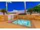 Cozy hot tub area featuring a stone surround and lush landscaping with city views in the distance at 2000 Fashion Show Dr # 5300, Las Vegas, NV 89109