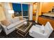 Comfortable living area with city views, wet bar, stylish furniture, and geometric patterned carpet at 2000 Fashion Show Dr # 5300, Las Vegas, NV 89109