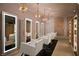Stylish salon with white chairs, lighted mirrors, decorative lighting, and a modern aesthetic at 2000 Fashion Show Dr # 5300, Las Vegas, NV 89109