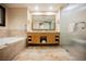 Bright bathroom with a double vanity, large mirror, soaking tub, and glass shower at 2000 N Fashion Show Dr # 4301, Las Vegas, NV 89109