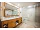 Bright bathroom with a double vanity, large mirror, soaking tub, and glass shower at 2000 N Fashion Show Dr # 4301, Las Vegas, NV 89109