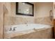 Close-up of elegant bathtub with tile surround and contemporary fixtures at 2000 N Fashion Show Dr # 4301, Las Vegas, NV 89109
