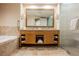 Bright bathroom with a double vanity, large mirror, soaking tub, and glass shower at 2000 N Fashion Show Dr # 4301, Las Vegas, NV 89109