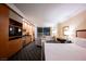 Hotel bedroom suite with kitchenette, king bed and sitting area overlooking city lights at 2000 N Fashion Show Dr # 4301, Las Vegas, NV 89109
