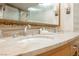 Close up on double vanity with marble countertop and decorative mirror at 2000 N Fashion Show Dr # 4301, Las Vegas, NV 89109