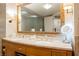 Bathroom featuring a double sink vanity with marble countertops and decorative mirror at 2000 N Fashion Show Dr # 4302, Las Vegas, NV 89109