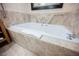 Bathroom featuring a soaking tub with marble tile surround for a relaxing spa-like experience at 2000 N Fashion Show Dr # 4302, Las Vegas, NV 89109