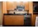 Hotel kitchenette featuring stainless steel microwave, compact sink, and efficient storage cabinets at 2000 N Fashion Show Dr # 4302, Las Vegas, NV 89109