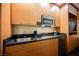 Close-up view of a hotel kitchenette, equipped with modern appliances and granite countertops at 2000 N Fashion Show Dr # 4302, Las Vegas, NV 89109