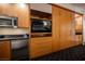 A kitchenette with granite countertops, stainless steel appliances and custom wood cabinetry at 2000 N Fashion Show Dr # 4302, Las Vegas, NV 89109