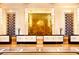 Elegant lobby area with reception desks, marble floors, chandelier lighting and gold wall art at 2000 N Fashion Show Dr # 4302, Las Vegas, NV 89109