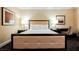 Plush king-size bed featuring two nightstands with elegant lamps and artwork on the walls at 2000 N Fashion Show Dr # 4302, Las Vegas, NV 89109