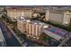 Aerial view of condo buildings, a tennis court, pool, and lovely landscaping at 205 E Harmon Ave # 1007, Las Vegas, NV 89169