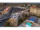 An aerial view showing the property with amenities like a pool, tennis court, and cityscape at 205 E Harmon Ave # 1007, Las Vegas, NV 89169