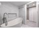 Modern bathroom featuring an oval tub, stylish fixtures, and white marble-patterned tile at 205 E Harmon Ave # 1007, Las Vegas, NV 89169
