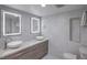 Stylish bathroom featuring double sinks, lit mirrors, and modern fixtures at 205 E Harmon Ave # 1007, Las Vegas, NV 89169