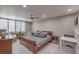 This bedroom boasts a ceiling fan, desk, stylish decor, and natural light from the window at 205 E Harmon Ave # 1007, Las Vegas, NV 89169