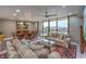 Bright living room with dining area, plush seating, and a large sliding glass door to a balcony at 205 E Harmon Ave # 1007, Las Vegas, NV 89169