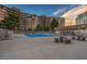Community pool, with lounge chairs, tables, and seating areas, adjacent to the building at 205 E Harmon Ave # 1007, Las Vegas, NV 89169