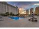 The pool area features lounge seating and landscaping in a community setting at 205 E Harmon Ave # 1007, Las Vegas, NV 89169
