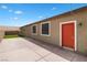 Backyard view features a concrete patio, turf lawn, and a door for outdoor access at 2091 Hunt Woods Ct, Laughlin, NV 89029